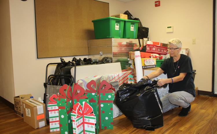 Toys for Tots coordinator Inga Dwyer packs up supplies ahead of the organization’s move out of Lake Shore Hospital property. (TONY BRITT/Lake City Reporter)