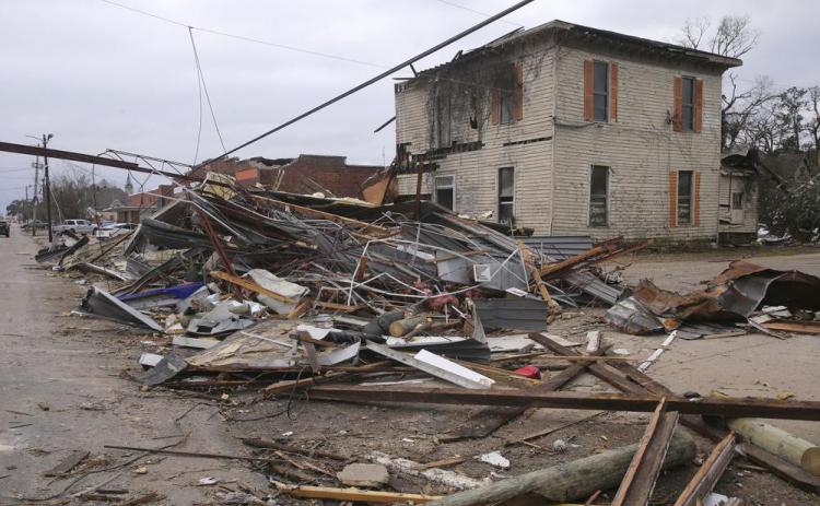 Debris from local businesses covers the street in Selma, Ala., on Jan. 13 after a tornado passed through the area. After three nasty years, the La Nina weather phenomenon is gone, the National Oceanic and Atmospheric Administration said Thursday. (STEW MILNE/AP file)
