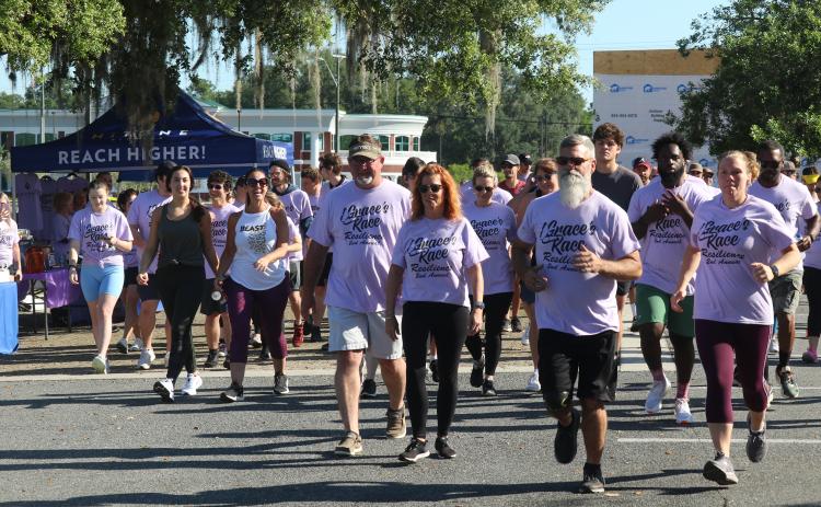 Grace Duncan’s parents, Burt and Cissy (center) help lead the start of last year’s Grace’s Race 5K. The third annual race is scheduled for Saturday at the Heritage Oaks Circle Shopping Center. (FILE)