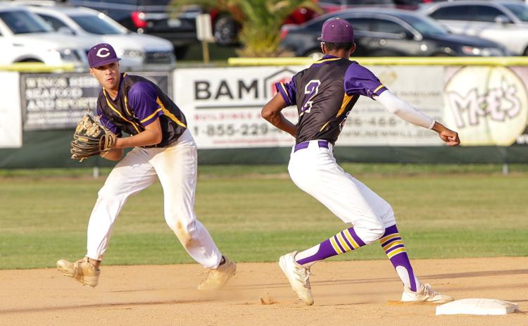 Columbia second baseman Grant Bowers sets to flip the ball to shortstop Brayden Thomas for an out against Union County on April 19. (BRENT KUYKENDALL/Lake City Reporter)