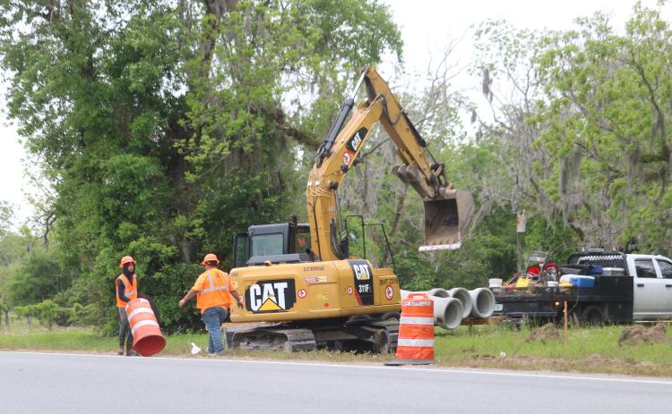 A crew with Anderson Columbia sets up barricades along the side of State Road 47 on Monday as work began on a widening and resurfacing project. (TONY BRITT/Lake City Reporter)