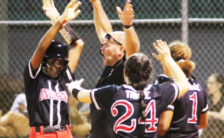 Fort White catcher Morgan (left) celebrates with coach Chad Padgett (middle) and pitcher Kadence Compton (24) after hitting a walk-off RBI single to defeat Baldwin on Thursday night. (JORDAN KROEGER/Lake City Reporter)