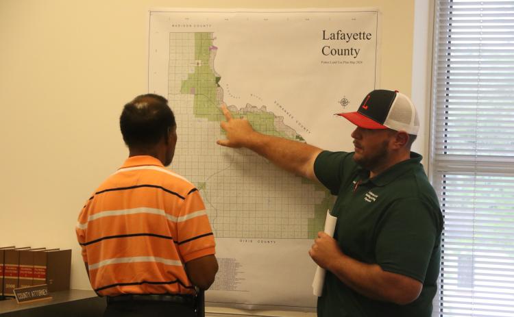 Lafayette County Building/Zoning Director Garrett Land (right) looks at the county’s future plan use map with Commission Chairman Earnest Jones during a workshop Tuesday on RV sites. (MORGAN MCMULLEN/Lake City Reporter)