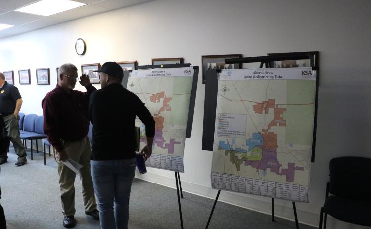 Lake City Assistant Police Chief Andy Miles (left) looks over the proposed redistricting maps with Joshua Garner after the Lake City Council’s workshop Tuesday. (MORGAN MCMULLEN/Lake City Reporter)