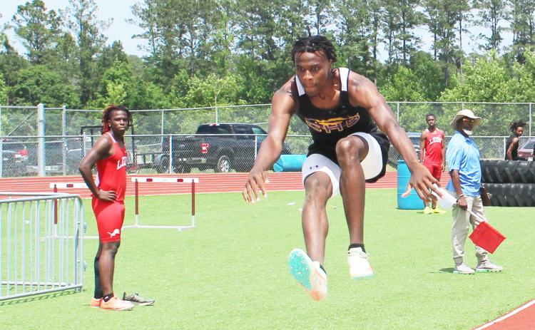Columbia’s Seth Stockton leaps in the triple jump during the District 2-3A meet on Friday. (COURTESY)