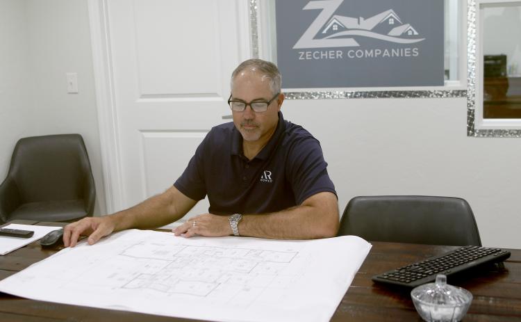 Bryan Zecher, looking over blueprints for a home in the Zecher Companies’ office on State Road 47, has been named the best Custom Builder in the U.S., according to the Avid Ratings’ annual awards, which are based on customer satisfaction surveys. (FILE)