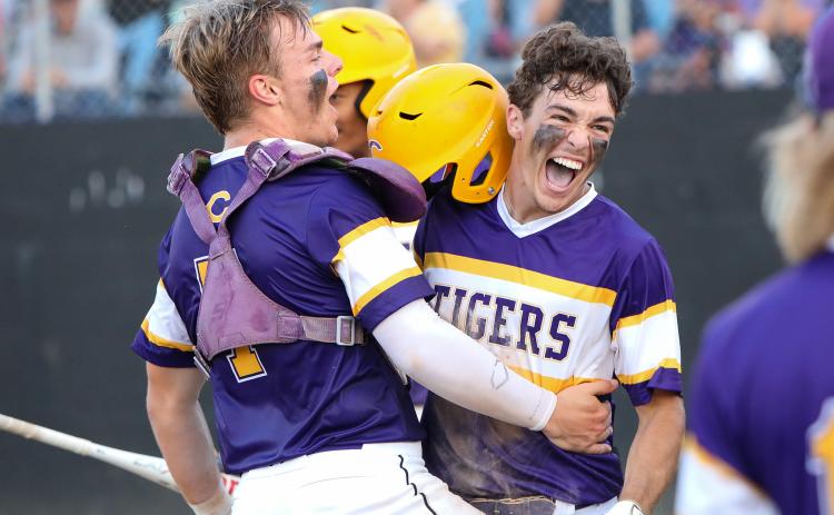 Columbia outfielder Carston Palmer (right) celebrates with catcher Hayden Gustavson after scoring a run against Pine Forest during the Region 1-5A quarterfinals on Tuesday night. (BRENT KUYKENDALL/Lake City Reporter)