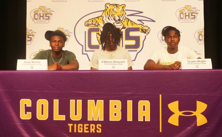Columbia basketball players Isaac Broxey (from left), D’Maceo Sheppard and Ty’jahn Wright signed letters of intent to play at Florida Gateway College on Wednesday. (JORDAN KROEGER/Lake City Reporter)