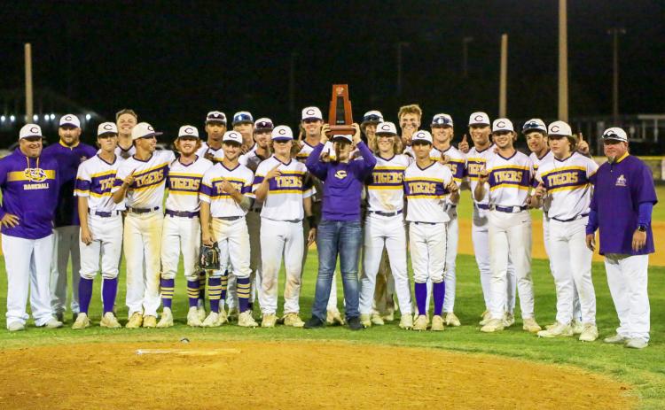 Columbia celebrates with the District 2-5A championship trophy after defeating Lincoln 9-0 on Wednesday night. (BRENT KUYKENDALL/Lake City Reporter)
