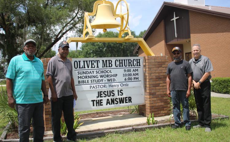 Members of the Olivet Missionary Baptist Church military ministry (from left) Thomas Acree, Harold Perry, Sean Dunmore and church pastor Henry Ortiz placed a total of more than 2,000 flags in 17 local cemeteries in honor of veterans on Memorial Day. (TONY BRITT/Lake City Reporter)