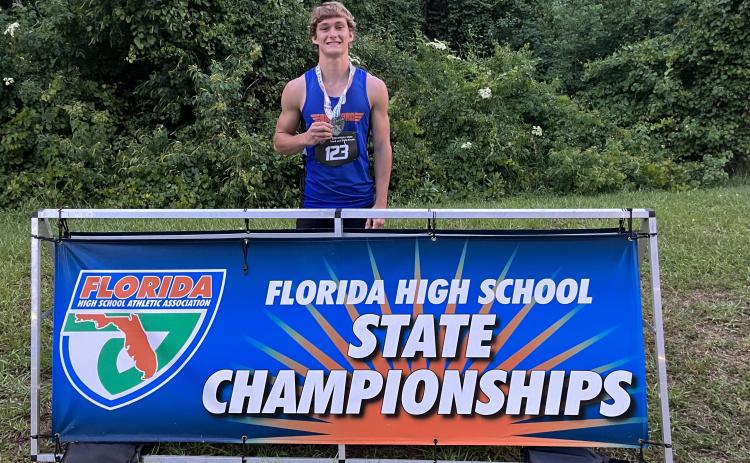 Branford’s Cash Blalock is pictured with his seventh-place medal in the high jump at the Class 1A state meet on Wednesday at Hodges Stadium in Jacksonville. (COURTESY)