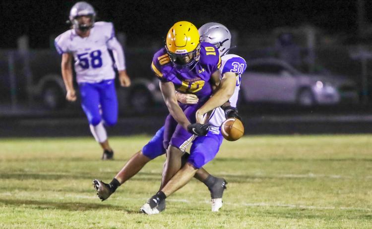 Columbia receiver Zamarion Jones is stripped by Bartram Trail linebacker Josiah Smith during Friday’s spring game. (BRENT KUYKENDALL/Lake City Reporter)
