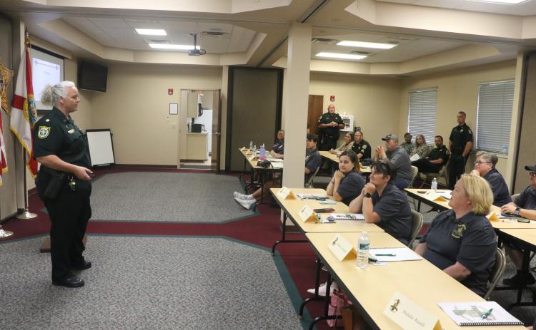 Columbia County Sheriff’s Office Maj. Katina Dicks (left) answers a question from a participant during Tuesday’s Citizen’s Law Enforcement Academy. (MORGAN MCMULLEN/Lake City Reporter)