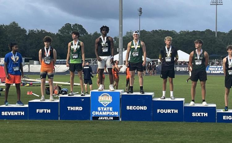 Suwannee junior Will Wainwright stands on the podium Thursday at Hodges Stadium in Jacksonville after finishing second in the javelin in Class 2A. (COURTESY)