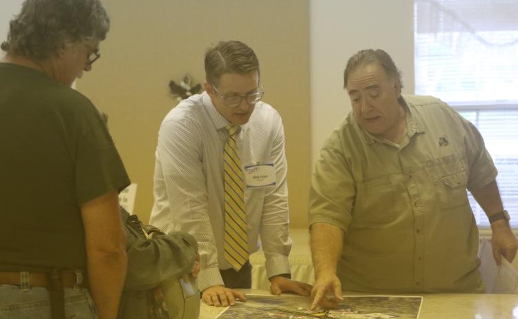 Tim Liguori (right) talks with Florida Department of Transporation’s Nick Hope about the state’s plans for the State Road 247 and County Road 240 intersection during an open house Thursday. (JAMIE WACHTER/Lake City Reporter)