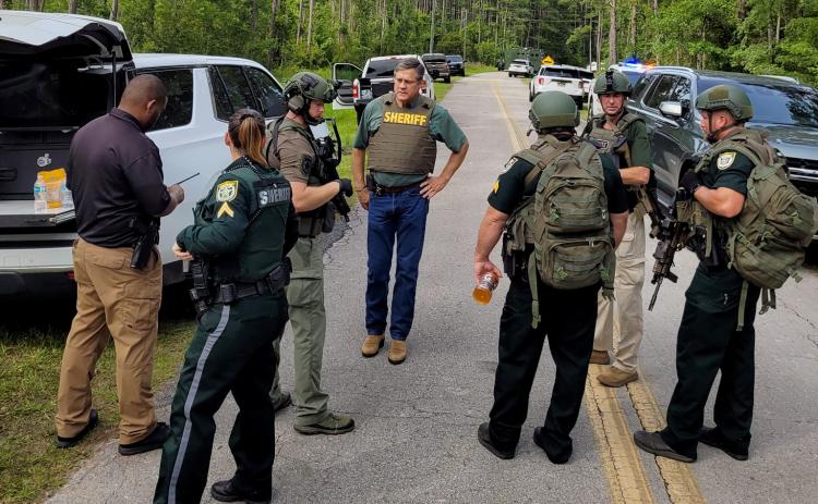 Columbia County Sheriff Mark Hunter (middle) and law enforcement officers stand near the scene of Monday's events on Mershon Street north of Lake City. (COURTESY CCSO)