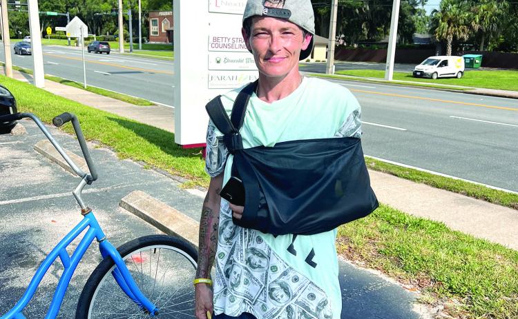 Brandy Dent is pictured at the Oak Bridge office building Friday, two days after she said she helped stop a car from backing over a child. (JAMIE WACHTER/Lake City Reporter)