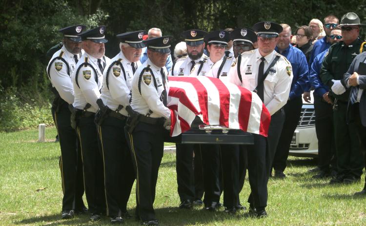 Former Jasper Police Chief Anthony ‘Tony’ Rickerson’s flag-draped casket is carried into the cemetery at Burnham Christian Church in Jennings by the honor guard Tuesday. (MORGAN MCMULLEN/Lake City Reporter)