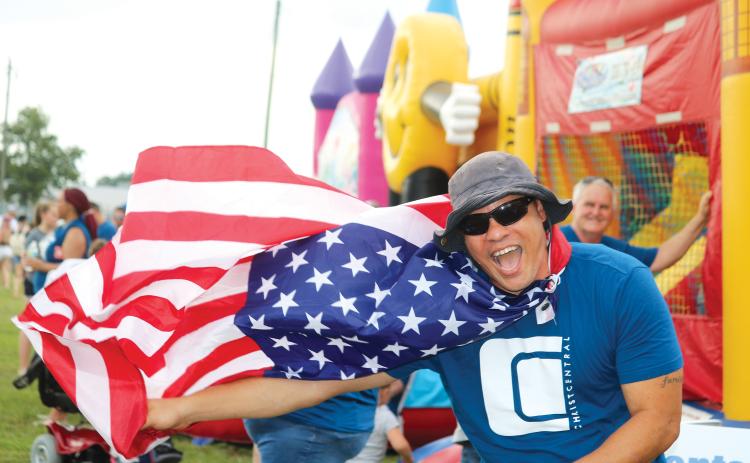 Earnest Burch waved down festival-goers with his Old Glory cape at the 2019 Independence Day event at the Columbia County Fairgrounds. After no festival a year ago, the City of Lake City and the Rotary Club of Lake City are bringing a full slate of activities to the banks of Lake DeSoto this year. (FILE)