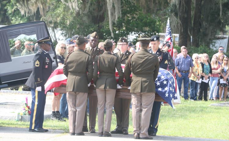The casket of U.S. Army Cpl. Alton Christie is carried to his final resting place at Evergreen Cemetery in Jasper on Saturday morning. Hundreds of friends, family members and supporters gathered for Christie’s funeral. (MORGAN MCMULLEN/Lake City Reporter)
