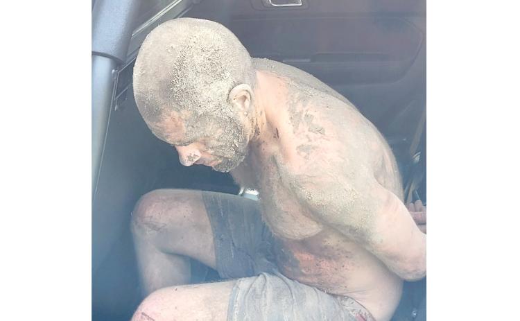 Scott Salanci is seated in a Columbia County Sheriff’s Office patrol car after hiding beneath a house Tuesday morning. (COURTESY COLUMBIA COUNTY SHERIFF’S OFFICE)
