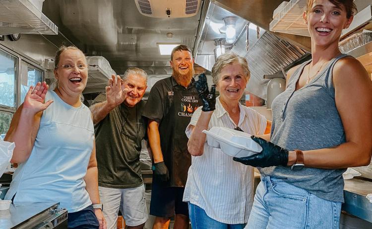 Robert and Emmie Chasteen sold their Chasteen’s Still Truckin’ food truck to Cammy and Ben Scott and Holly and Jonny Frazier. The rebranded truck, Cluckin’ and Truckin’ will hopefully start serving next week. The Chasteens helped Cammy Scott (left), Jonny Frazier (middle) and Holly Frazier (right) during a private event. (COURTESY)