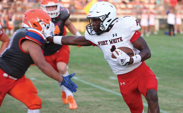 Fort White running back Dakota Fisher stiff arms a Branford defender during Friday night’s three-team jamboree at Trenton. (PAUL BUCHANAN/Special to the Reporter)