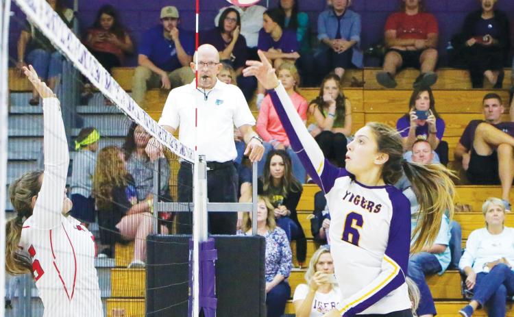 Columbia’s Sinei Wood hits a shot over the net against Fort White last season. (BRENT KUYKENDALL/Lake City Reporter)