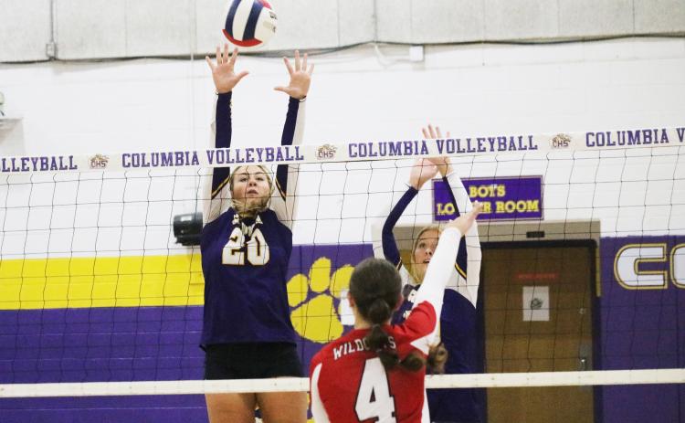 Columbia’s Cassidy O’Neal (20) and Avery Sandlin (right) try to block a shot from Baker County on Thursday night. (JORDAN KROEGER/Lake City Reporter)