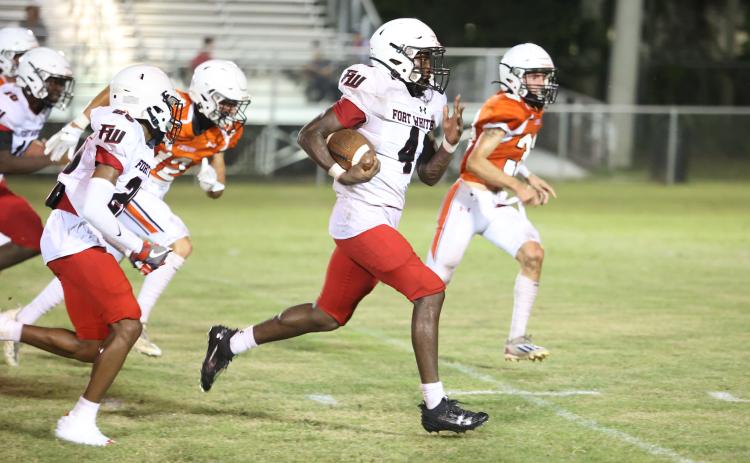 Fort White running back Maliki Clark takes a carry up the field against Trenton during last Friday’s jamboree. (PAUL BUCHANAN/Special to the Reporter)