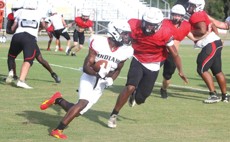 Fort White running back Dakota Fisher takes a carry up the field during Friday’s scrimmage. (MORGAN MCMULLEN/Lake City Reporter)