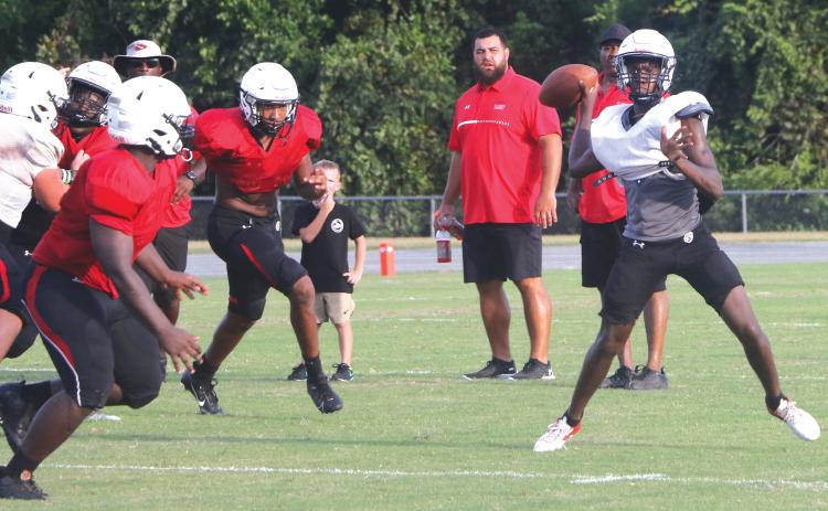 Fort White quarterback Jayden Jackson rolls out to throw a pass during Friday’s team scrimmage. (MORGAN MCMULLEN/Lake City Reporter)