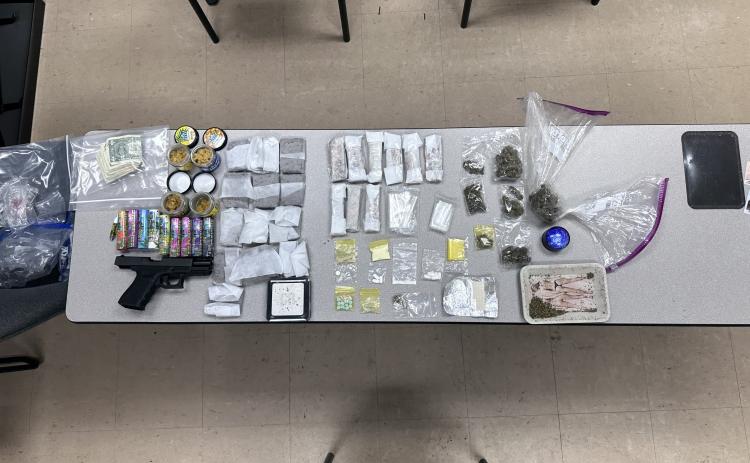 A traffic stop Saturday led to two arrests after Lake City police officers found a variety of narcotics and a firearm in the vehicle. (COURTESY LCPD)