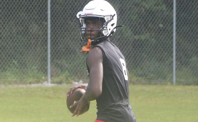 Fort White quarterback Jayden Jackson sets to throw a pass during Monday’s practice. (MORGAN MCMULLEN/Lake City Reporter)