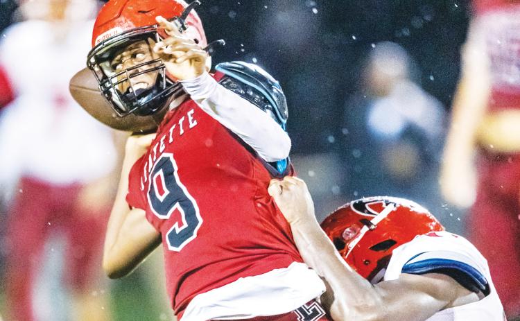 Lafayette quarterback Tywan Williamson throws a pass under pressure against Hamilton County last season. (FILE)