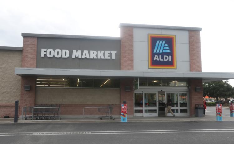 A shopper enters the Aldi store in Lake City on Wednesday afternoon. The Germany-based company announced Wednesday it plans to buy 400 Winn-Dixie and Harveys stores in the southeast. (MORGAN MCMULLEN/Lake City Reporter)