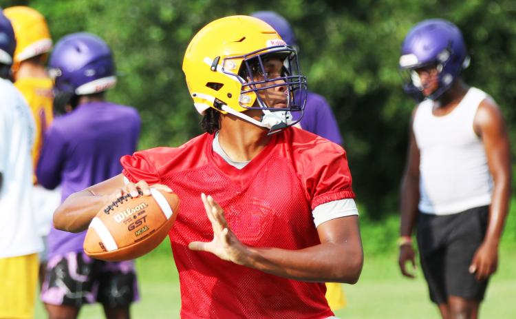 Columbia quarterback Zack Paulk drops back to pass during Monday’s practice. (JORDAN KROEGER/Lake City Reporter)