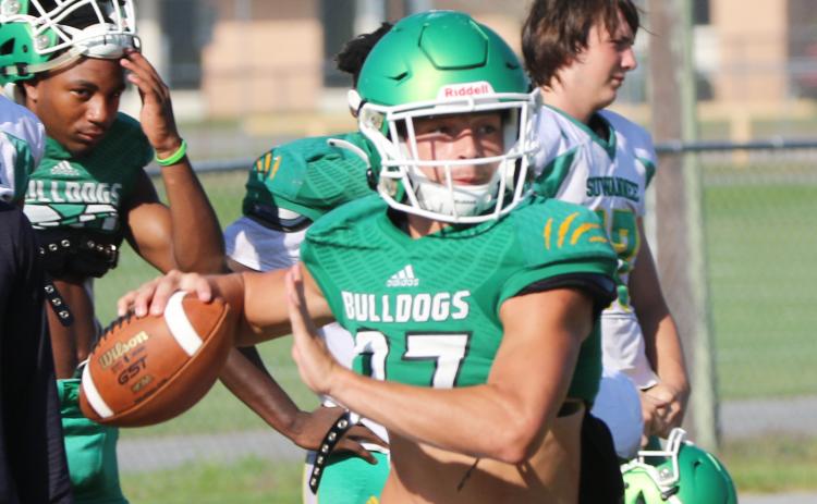 Suwannee quarterback Kodi Lang rolls out to throw a pass during Tuesday’s practice. (JAMIE WACHTER/Lake City Reporter)