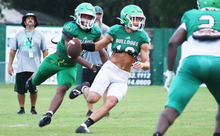 Suwannee defensive end Ja’Darius Cherry sacks quarterback Kodi Lang during Friday’s scrimmage. (JAMIE WACHTER/Lake City Reporter)