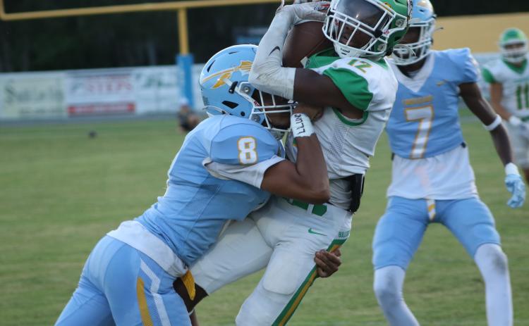 Suwannee wide receiver Daijuan Perkins catches a pass Friday night as a Chiefland defensive back delivers a hit at Pridgeon Stadium. (JAMIE WACHTER/Lake City Reporter)