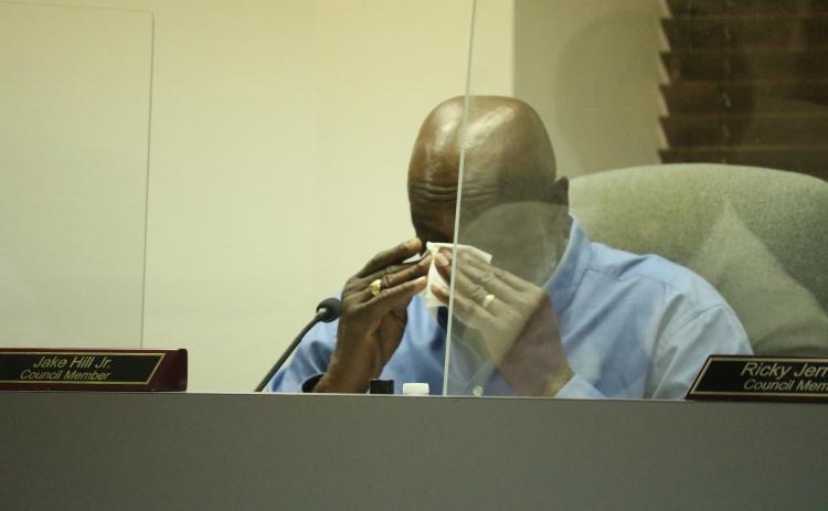 Lake City Councilman Jake Hill Jr. wipes his eyes while talking about Mariah Smith, a close family friend. Smith, 12, was shot and killed last month. The council supported designating NW Long Street in her honor. (JAMIE WACHTER/Lake City Reporter)