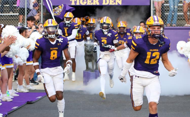 Columbia defensive back Markeyon Moore (8) and receiver Camdon Frier (12) lead their team on to the field prior to their game against Buchholz on Aug. 25. (BRENT KUYKENDALL/Lake City Reporter)