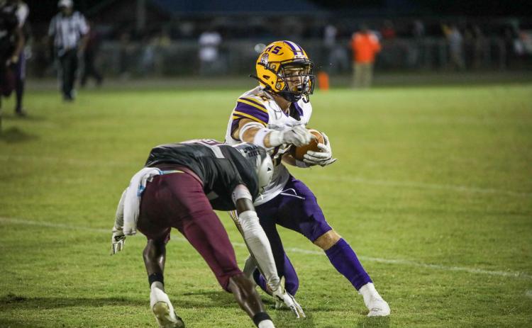 Columbia wide receiver Camdon Frier makes a move against a Madison County defender after a catch Friday night at Boot Hill. (BRENT KUYKENDALL/Lake City Reporter)