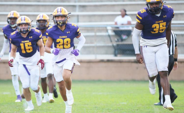 Columbia defensive back Julian De La Cruz (28) and linebacker Chris Jordan (35) celebrate after making a tackle on a kickoff return against Buchholz on Aug. 26.
