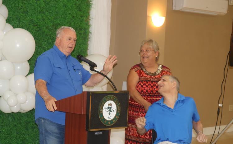 Gary Campbell (from left) addresses the audience at the United Way of Suwannee Valley fundraising kickoff event while accompanied by Beverly Standridge and his son, Michael Campbell. (TONY BRITT/Lake City Reporter)