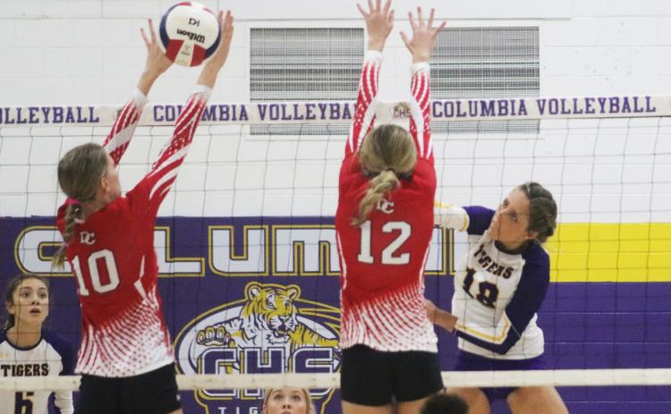 Columbia outside hitter Autumn Jones sends a shot past Dixie County’s Hailey Moody (10) and Kailey Edmonds (12) on Wednesday night. (JORDAN KROEGER/Lake City Reporter)
