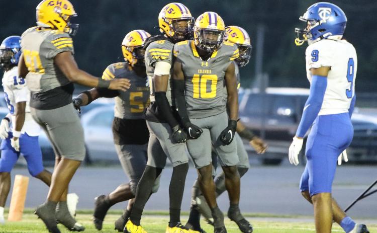 Columbia receiver Zamarion Jones celebrates with teammates after picking up yardage against Trinity Christian on Friday. (BRENT KUYKENDALL/Lake City Reporter)