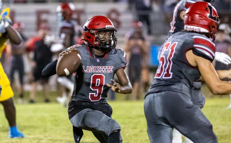 Lafayette quarterback Tywan Williamson scrambles to pass against Chiefland last Friday. (JACK HOWDESHELL/Special to the Reporter)