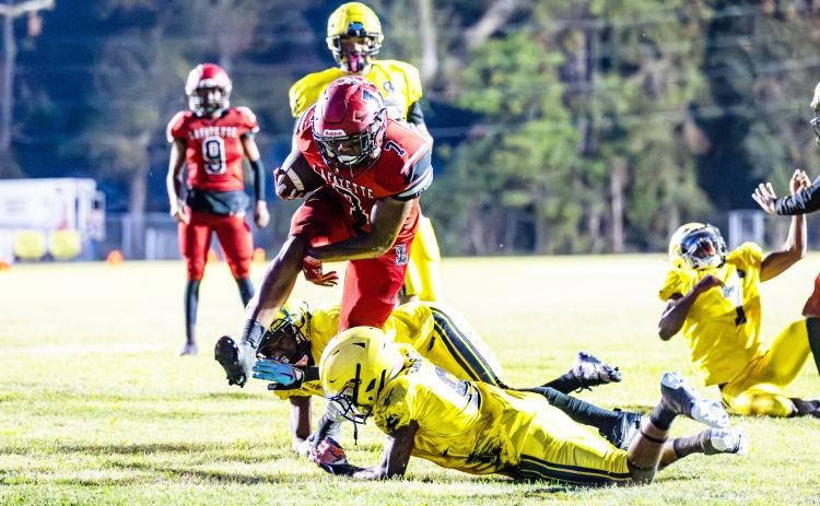Lafayette running back Jamarien Ervin leaps over a Zarephath Academy defender on Friday. (JACK HOWDESHELL/Special to the Reporter)