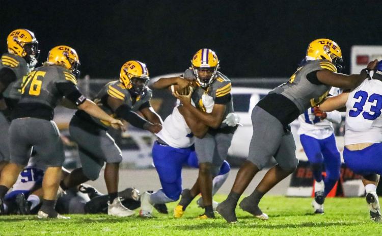 Columbia quarterback Zack Paulk tries to escape pressure from the Trinity Christian defense on Friday night. (BRENT KUYKENDALL/Lake City Reporter)